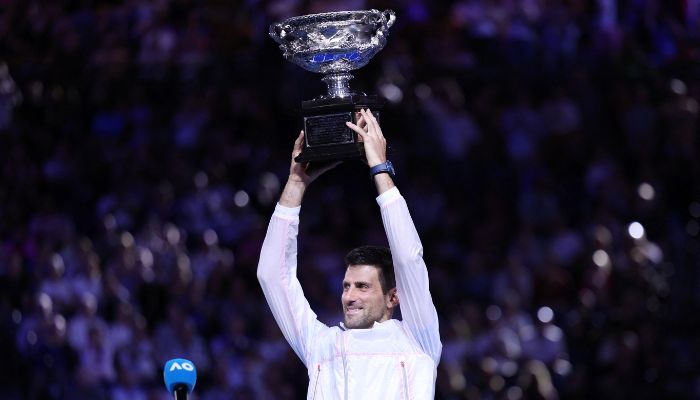 Novak Djokovic celebrates with the trophy after winning his final match against Greeces Stefanos Tsitsipas, on January 29, 2023. — Reuters