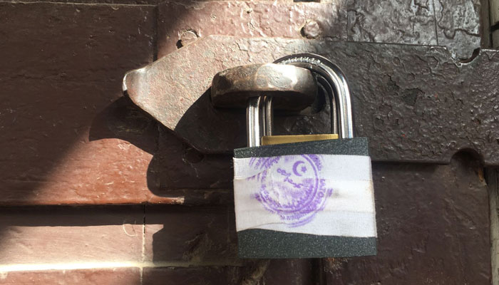 Padlock put up on one of the doors of Lal Haveli by the authorities. — Reporter