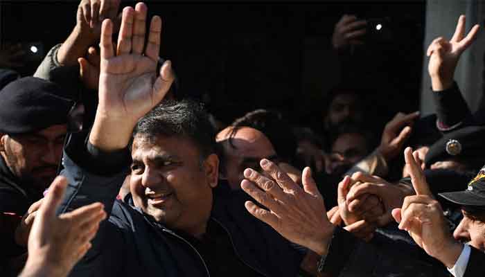 Former information minister Fawad Chaudhry (C) gestures as police officials escort him after a hearing at a court in Islamabad on January 27, 2023. —AFP