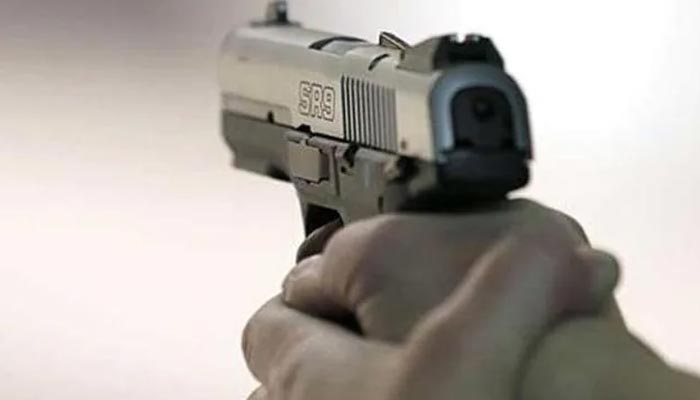 A representational image of a person holding a gun. — AFP