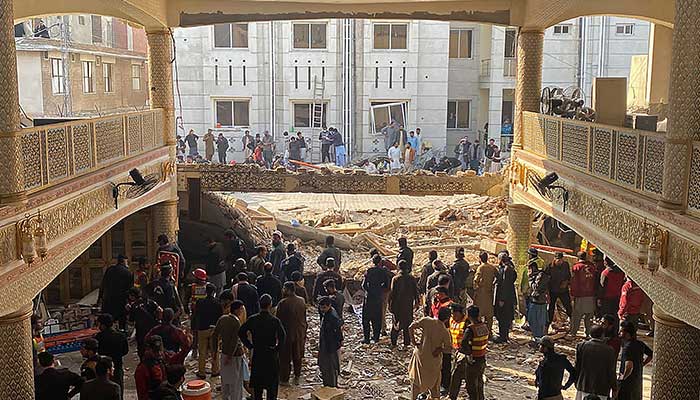 Security officials inspect the blast site inside the police headquarters in Peshawar on January 30, 2023. — AFP