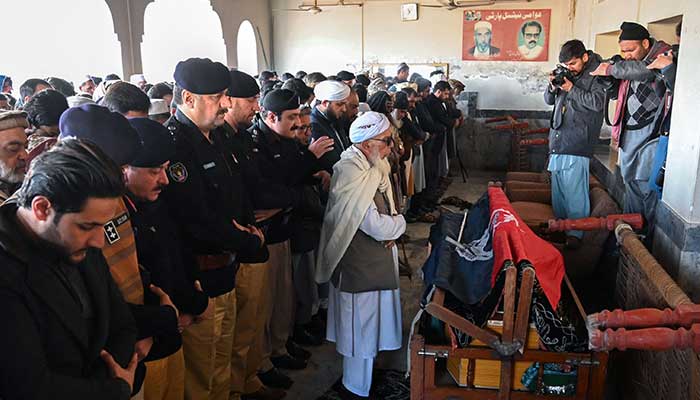 Security officials pray at the funeral of a policeman a day after the mosque blast inside the police headquarters in Peshawar on January 31, 2023. — AFP