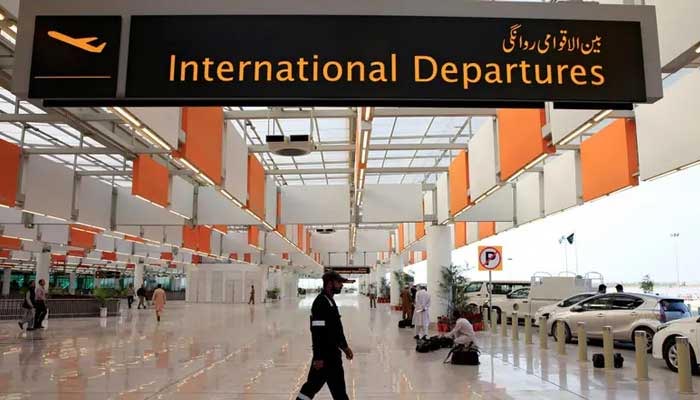 An airport staffer walks past the entrance of international departures at the Islamabad airport. — Reuters/File