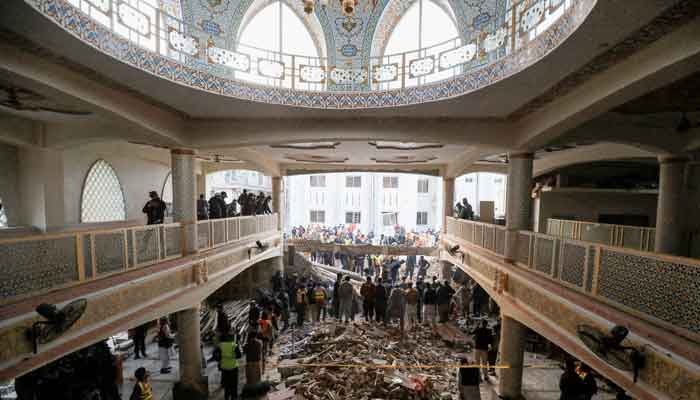 People and rescue workers gather to look for survivors under a collapsed roof, after a suicide blast in a mosque in Peshawar, Pakistan January 30, 2023. —Reuters