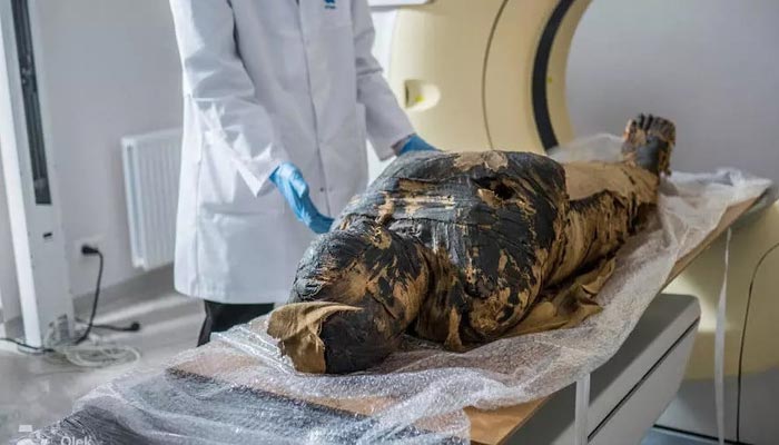 An undated photograph of an Egyptian mummy being scanned by a researcher. —AFP/File