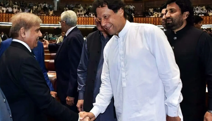 Prime Minister Shehbaz Sharif (left) shakes hands with PTI Chairman Imran (right) in the National Assembly. — Twitter/NAof Pakistan/File
