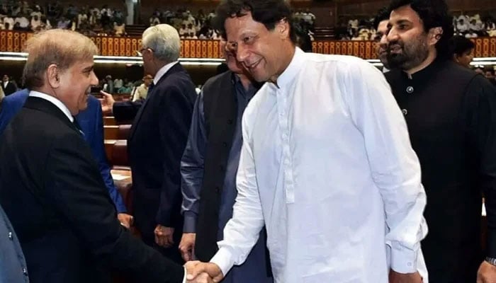 Prime Minister Shehbaz Sharif (left) shakes hands with PTI Chairman Imran (right) in the National Assembly. — Twitter/National Assembly/File