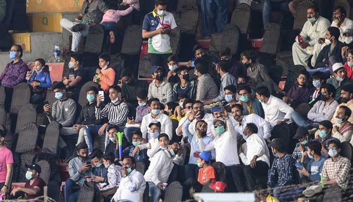 People watch the Pakistan Super League (PSL) T20 cricket match between Islamabad United and Quetta Gladiators at the National Stadium in Karachi on March 2, 2021. — AFP