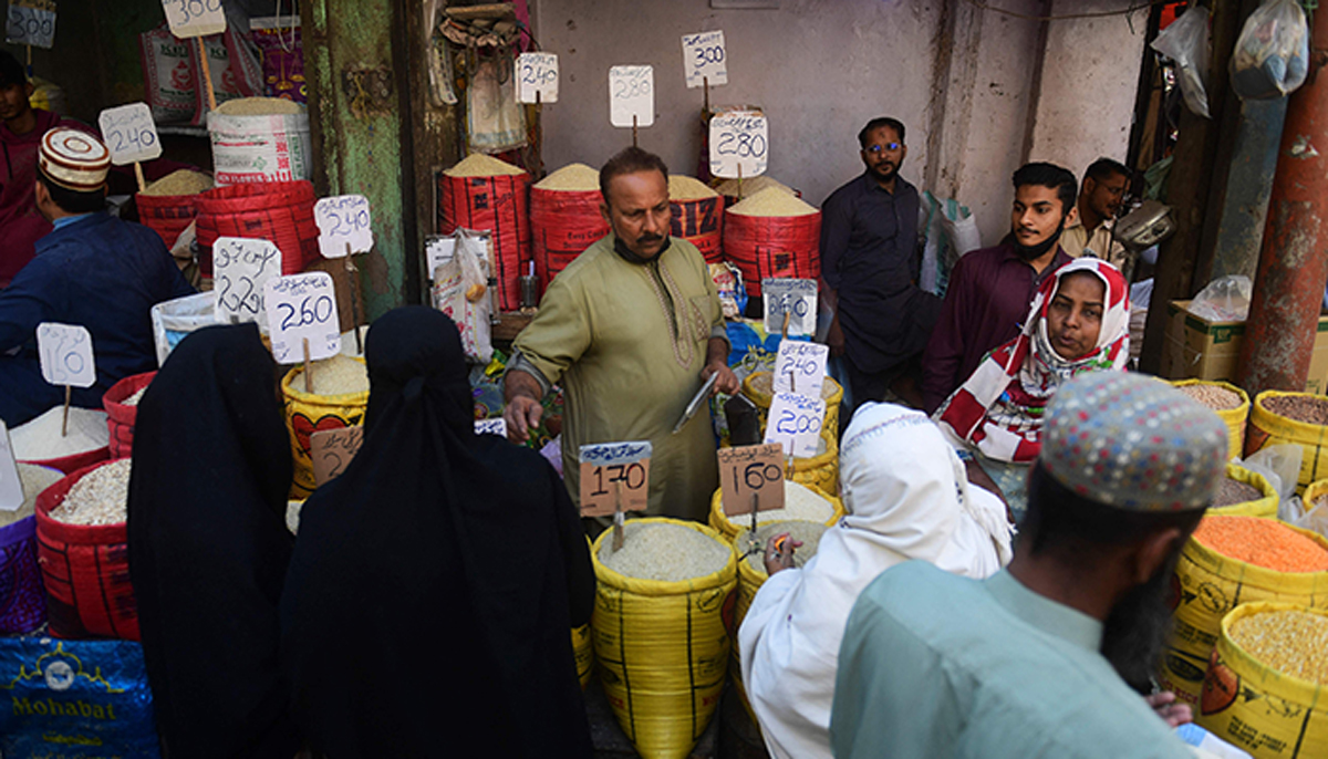 People buy rice at a market in Karachi on February 3, 2023. — AFP