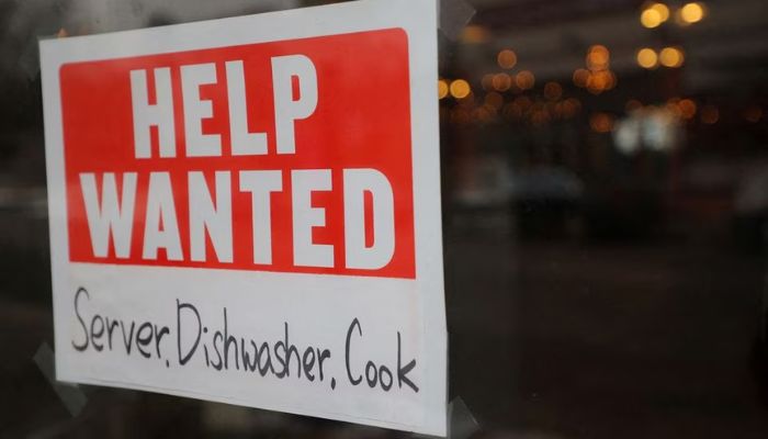 A Help Wanted sign hangs in restaurant window in Medford, Massachusetts, U.S., January 25, 2023.— Reuters