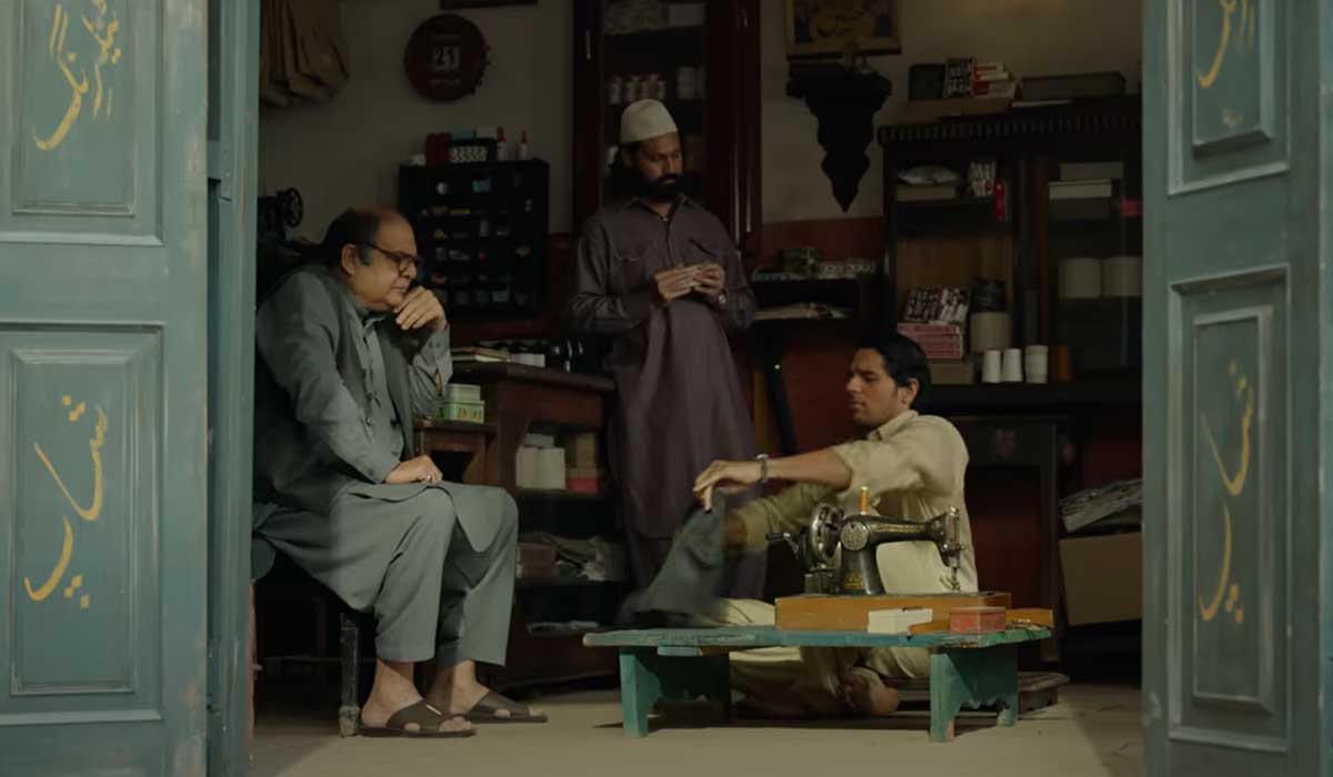 Scene from the movie showing the lead character playing a tailor. — Screengrab via YouTube/Netflix India