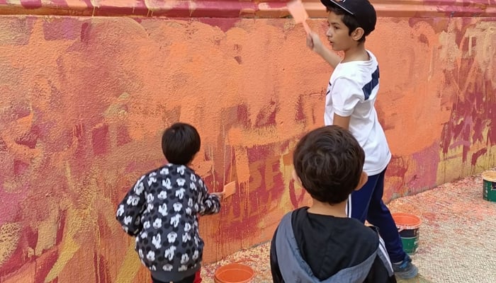Kids painting wall at the Karachi Wellness Festival on February 4, 2023. — Provided by the author