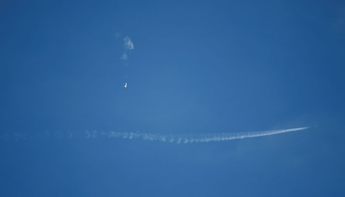 A jet flies by a suspected Chinese spy balloon after shooting it down off the coast in Surfside Beach, South Carolina, US. — Reuters