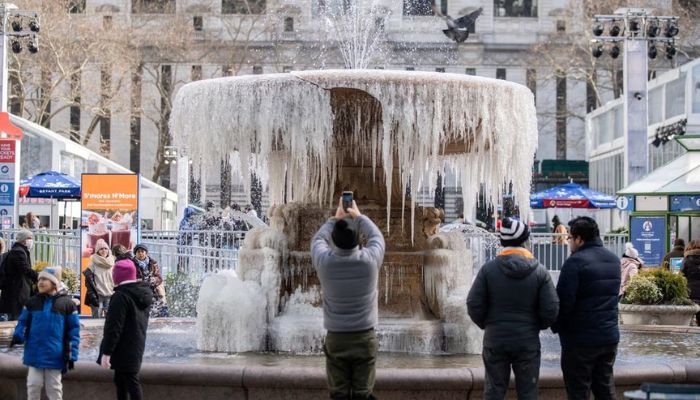 People take a selfie in front of a mostly frozen Bryant Park fountain during cold temperature and high winds in Manhattan, as deep cold spread across the northeast United States in New York City, New York, U.S., February 4, 2023.— Reuters