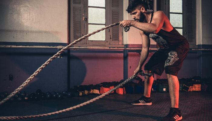 Man holding brown ropes.— Pexels