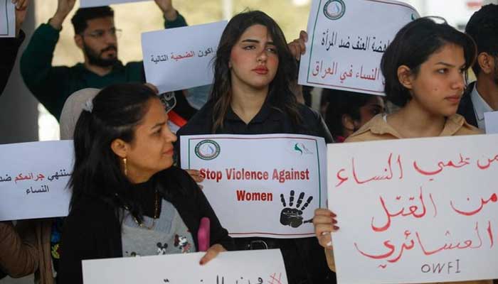 Iraqi womens rights activists lift placards during a rally near the Supreme Judicial Council in Baghdad on February 5, 2023, to protest the killing of Iraqi youtuber Tiba al-Ali by her father in Diwaniyah. — AFP
