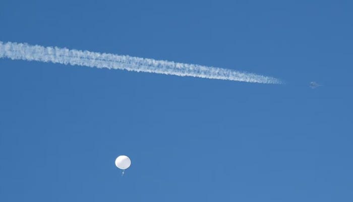 A jet flies by a suspected Chinese spy balloon as it floats off the coast in Surfside Beach, South Carolina, U.S. February 4, 2023. — Reuters