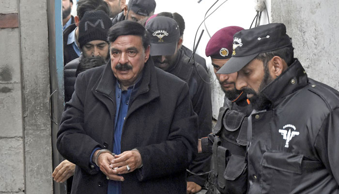 Police escort former interior minister Shiekh Rashid as he arrives to attend hearing at additional and sessions court in Islamabad. — Online