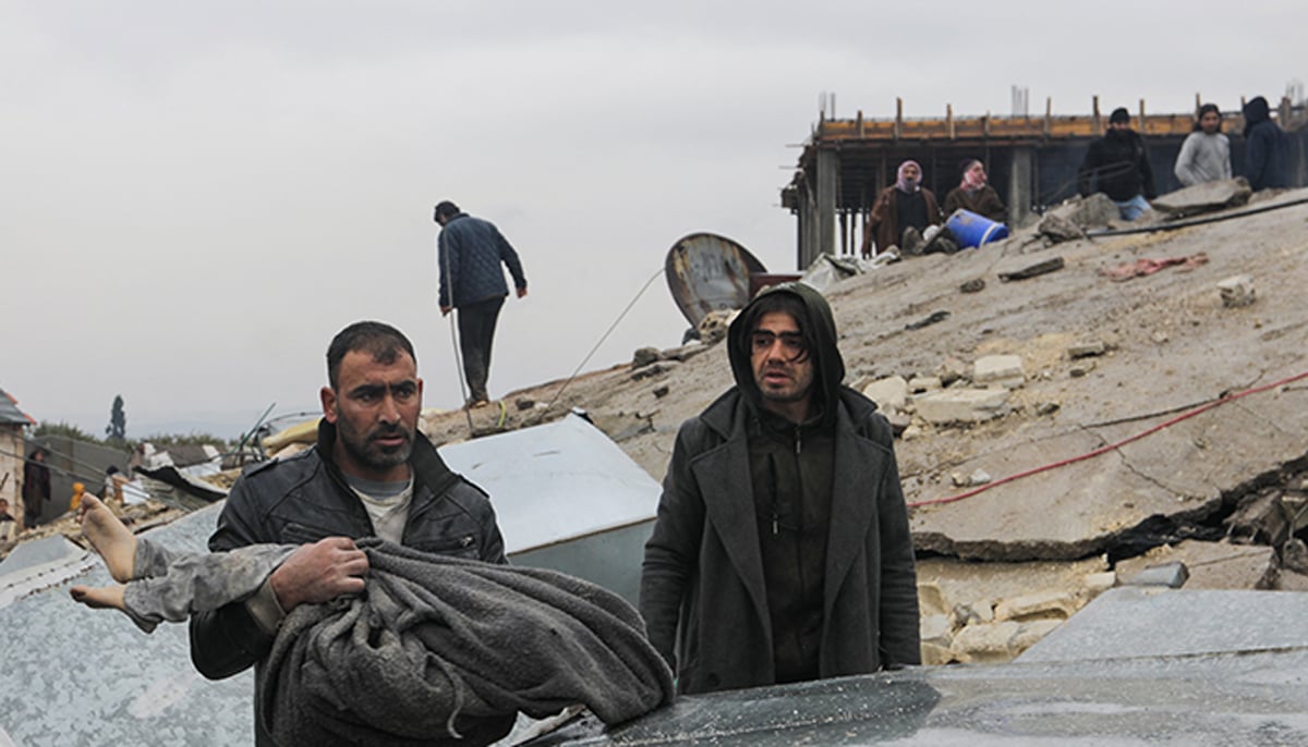 A man carries a victim as rescuers search for survivors under the rubble, following an earthquake, in rebel-held town of Jandaris, Syria February 6, 2023. — Reuters