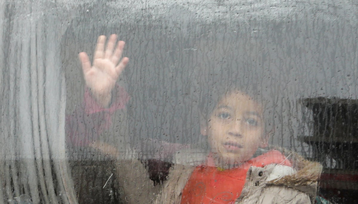 A child looks out through a window of a car, following an earthquake, in the rebel-held town of Jandaris, Syria February 6, 2023. — Reuters