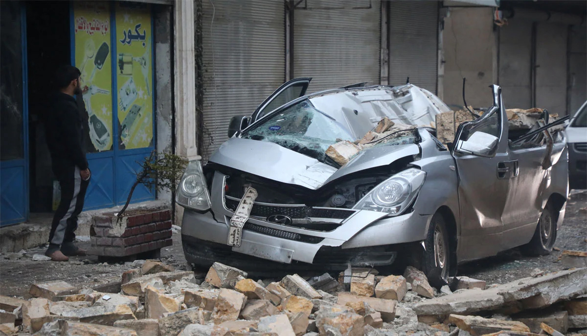 A man stands near a damaged vehicle, following an earthquake, in rebel-held Azaz, Syria. — Reuters