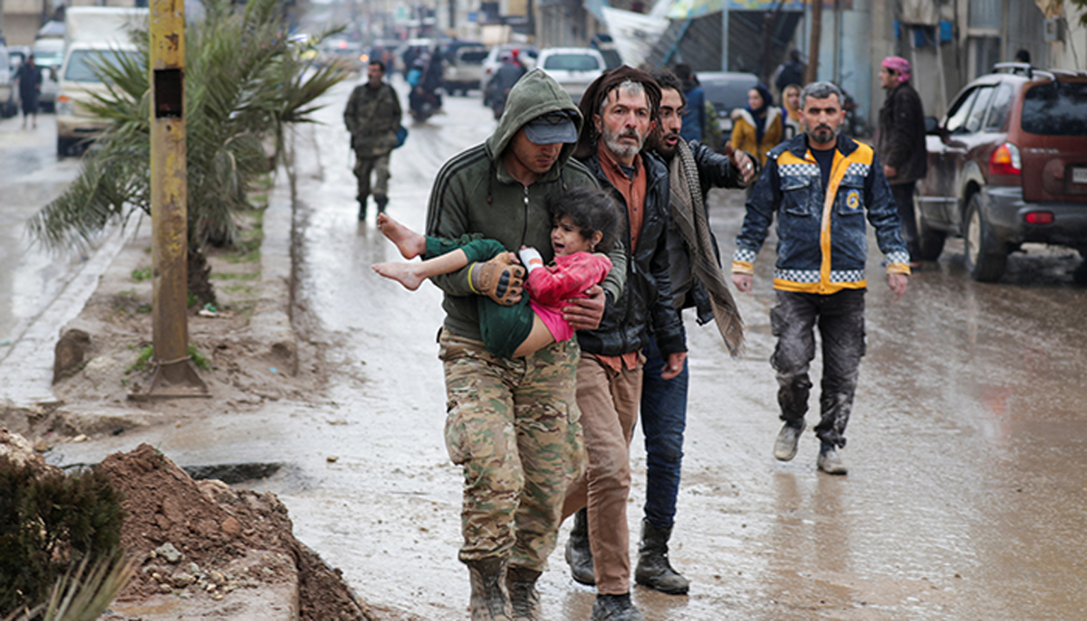 A girl is carried following an earthquake, in the rebel-held town of Jandaris, Syria February 6, 2023. — Reuters