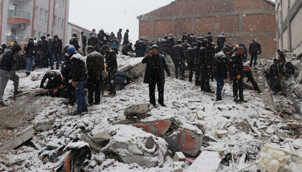Rescue workers carry out a person from a collapsed building after an earthquake in Malatya, Turkey. — Reuters