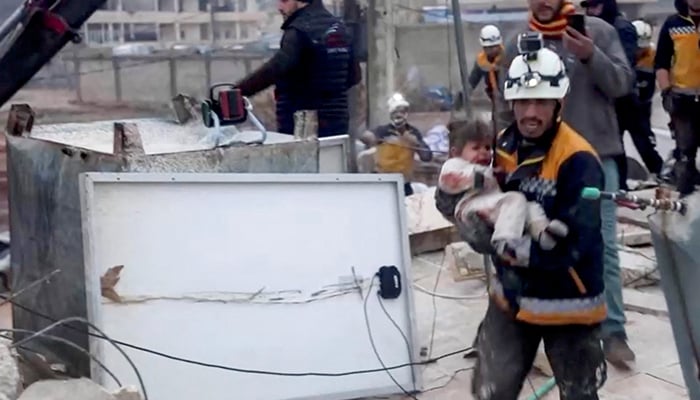 A rescuer carries an injured child away from the rubble of a building following an earthquake in rebel-held Azaz, Syria February 6, 2023, in this still image taken from video. — Reuters
