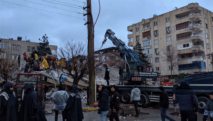 Rescue workers and volunteers search for survivors in the rubble of a collapsed building after the earthquake, in Sanliurfa, Turkey on February 6, 2023. — AFP