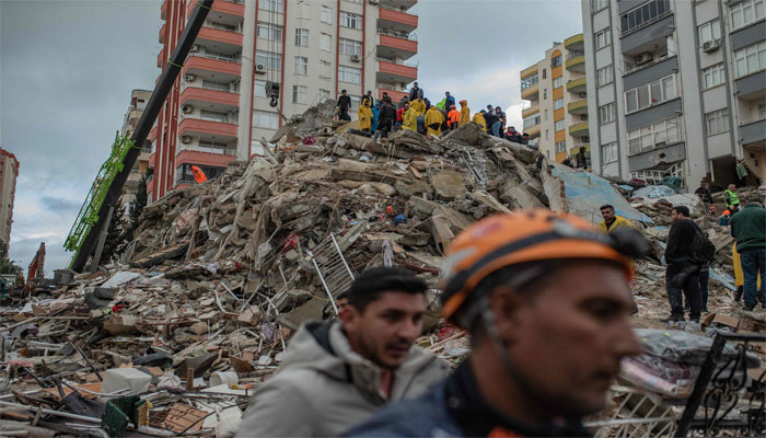 Rescuers search for victims and survivors amidst the rubble of a building that collapsed in Adana on February 6, 2023, after a 7.8-magnitude earthquake. — AFP.