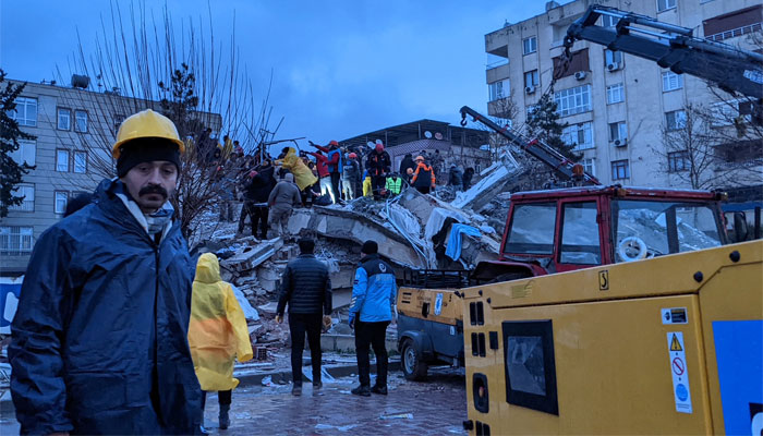 Rescue workers and volunteers search for survivors in the rubble of a collapsed building, in Sanliurfa, Turkey on February 6, 2023. — AFP