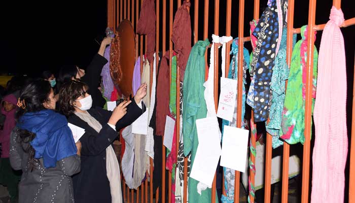 Members of civil society hang their scarves on the Fatima Jinnah Parks main gate while protesting on Saturday against the rape of a girl by two unidentified armed men at the F-9 park in Islamabad on February 6, 2023. — Online
