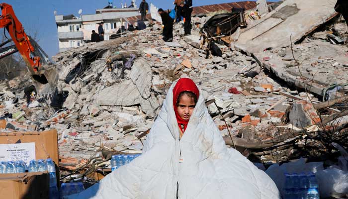 A girl sits near the site of a collapsed building following an earthquake in Kahramanmaras, Turkey February 8, 2023. — Reuters