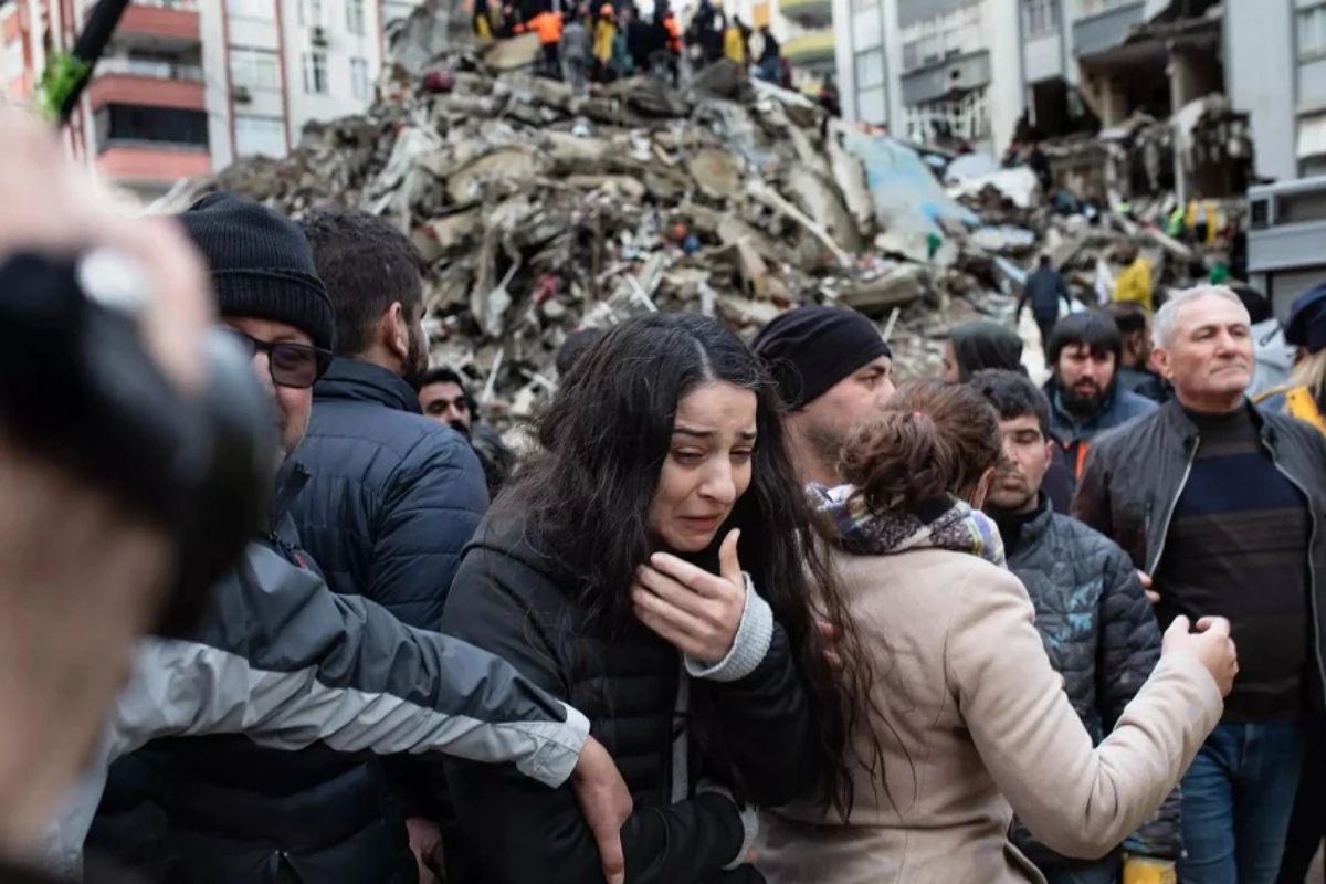 A girl reacts to the earthquake while walking among a crowd.— AFP/file