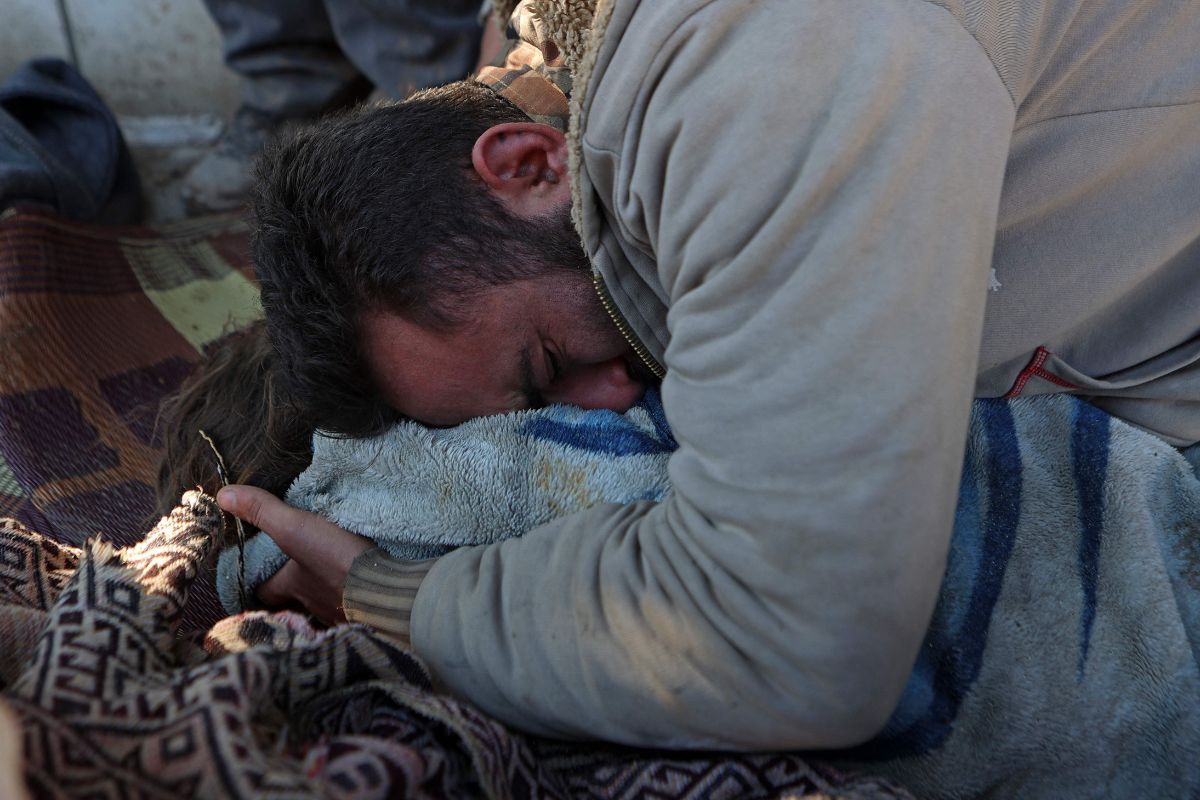 A Syrian man cries over the body of his lifeless child in Jindayris on February 7. — AFP