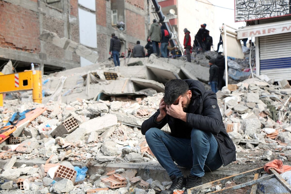 A man reacts as people search for survivors through the rubble in Diyarbakir. — AFP