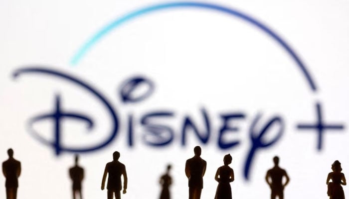 Toy figures of people are seen in front of the displayed Disney + logo, in this illustration taken January 20, 2022.— Reuters