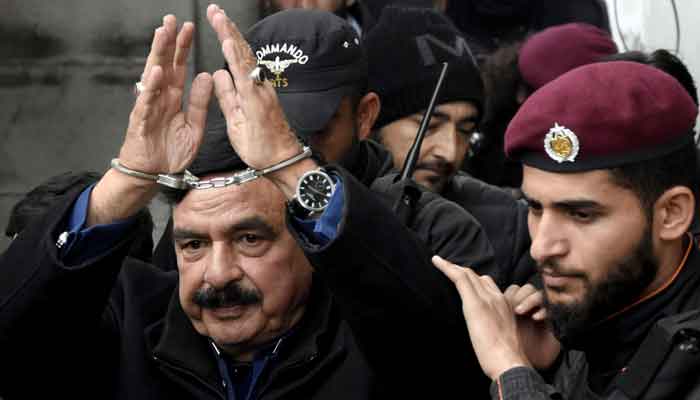 Police officials escort Awami Muslim League (AML) chief Shiekh Rashid as he arrives to attend a hearing at additional and sessions court in Islamabad. —Online