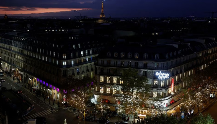 Christmas lights are viewed from the Galeries Lafayette department store, with the Eiffel Tower in the background in Paris, France, December 7, 2022. — Reuters