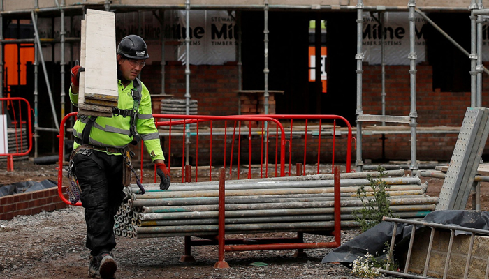 Builders work on a new Barratt Homes housing development near Warrington, Britain, August 6, 2020. — Reuters