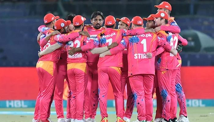 An undated photograph of Islamabad United huddling together during a match. — PCB