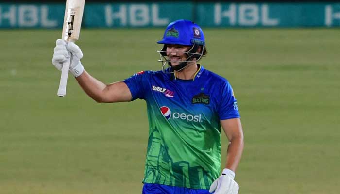 Multan Sultans Tim David waves his bat after fifty runs during the Pakistan Super League (PSL) Twenty20 cricket match between Multan Sultans and Peshawar Zalmi at the National Cricket Stadium in Karachi on February 5, 2022. — AFP