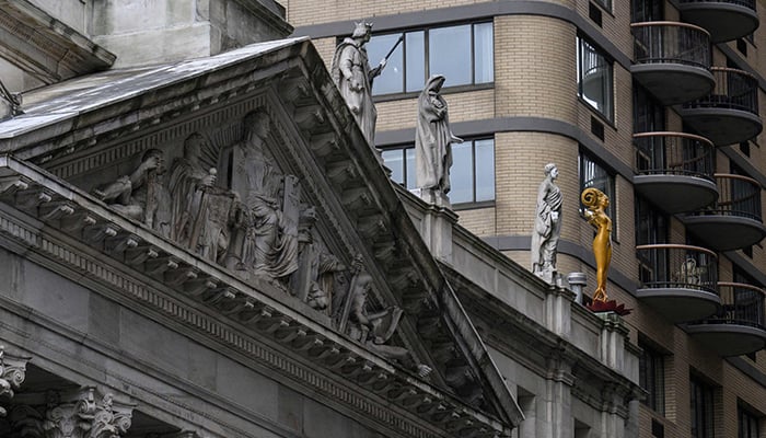 Shahzia Sikanders sculpture (right) stands atop the courthouse of the Appellate Division First Department of the Supreme Court near Madison Square Park as part of her multimedia exhibition to breathe, air, life on February 7, 2023, in New York City. — AFP