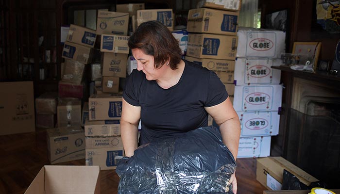 A woman packs a box with humanitarian aid for those affected by the 7.8 magnitude earthquake that hit Turkey and Syria, at the Turkish embassy in Bogota on February 10, 2023. — AFP