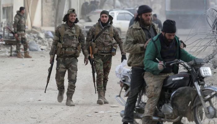 Members of Turkey-backed Syrian National Army walk on a street in the aftermath of an earthquake, in rebel-held town of Jandaris, Syria February 11, 2023. Reuters