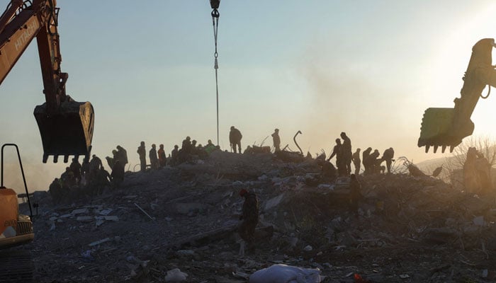 Rescuers search for survivors and victims amid destroyed buildings in Nurdagi, in the hard-hit region of Gaziantep, on February 12, 2023. — AFP