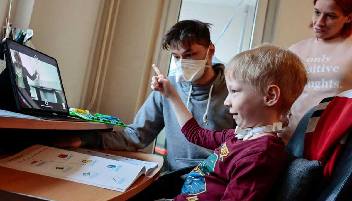 A seven-year-old schoolboy Joshua attends a school lesson, sitting beside his mother Simone and his brother Martin, via a robot avatar in his classroom, in Berlin, Germany, January 13, 2022. — Reuters