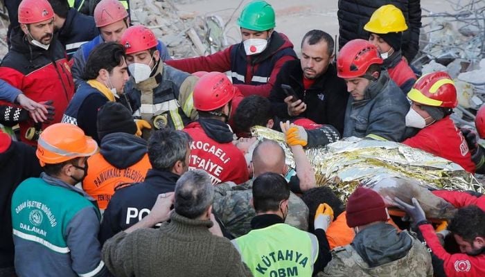Rescuer workers carry Kaan, a-13-year old Turkish teenager, to an ambulance after being rescued from the rubble after 182 hours, in the aftermath of a deadly earthquake in Hatay, Turkey February 13, 2023. Reuters
