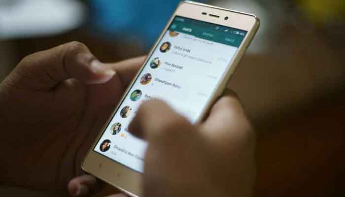 A representational image showing a person using WhatsApp on his/her smartphone. — AFP/File