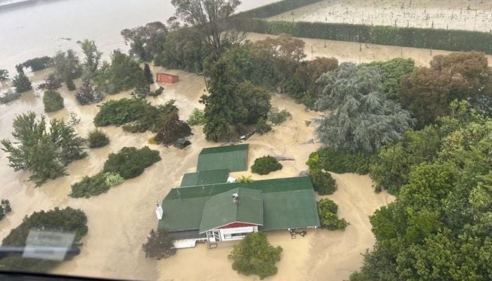 An NH90 helicopter and crew recover people from the rooftops of their homes in Esk Valley, Napier in this handout photo released on February 14, 2023.— Reuters